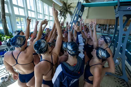 The Georgia Southern swimming team breaks a huddle during a tri-meet with SCAD-Savannah and Gardner-Webb.