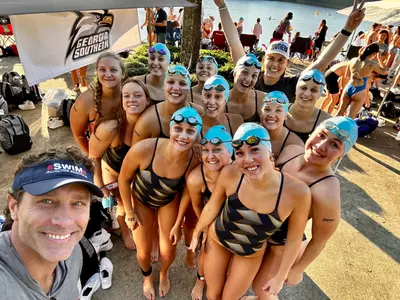 The Georgia Southern swim and dive team takes a group photo with head coach Allyson Sweeney and Swim Across America CEO (and Georgia Southern men's swim and dive alum) Rob Butcher.