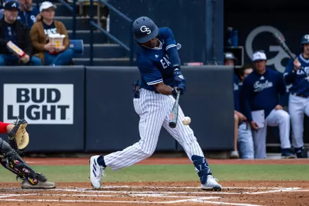 Georgia Southern outfielder T.J. McKenzie hits a ball during an NCAA baseball game.