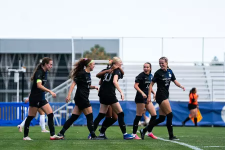 Clara Teigland celebrates with teammates after scoring against GCU