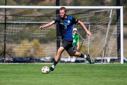 Doran Farrell dribbles the ball up the pitch at Cadet Soccer Stadium