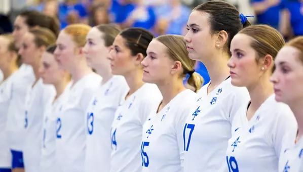 The team stands during the national anthem before their match against Little Rock.