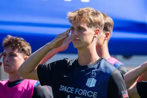 Quinn Muderlak salutes during the pregame national anthem