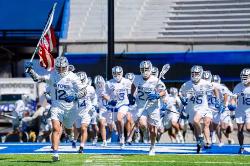 Ryan Stadelmaier runs out with the American flag headed into the Senior Day game against Mercer