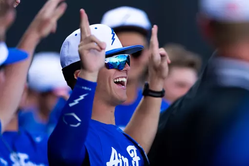 Baseball player cheers from dugout at Erdle Field
