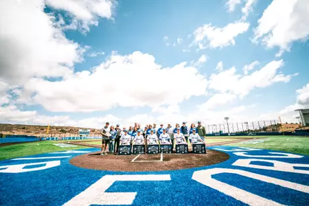 The 2026 baseball senior class poses with their families and coaches on senior day at Erdle Field against Washinton State