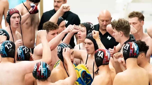 Air Force men's water polo huddle in game.