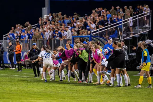 Maddy Walsh is cheered on by the women's soccer team after scoring her second goal against Army