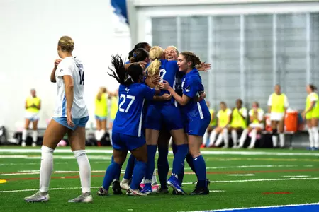 The women's soccer team celebrates with Gianna Gigliotti after scoring against Creighton