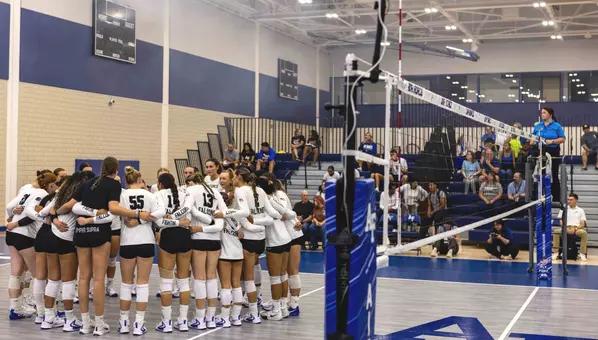 The volleyball team huddled up before its exhibition match against Mines on Aug 20.