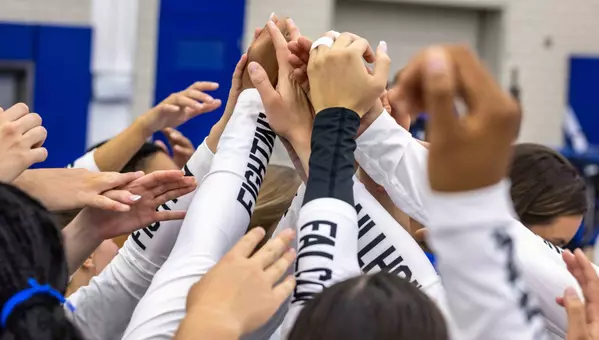 The Falcons huddle up before their exhibition against Mines.