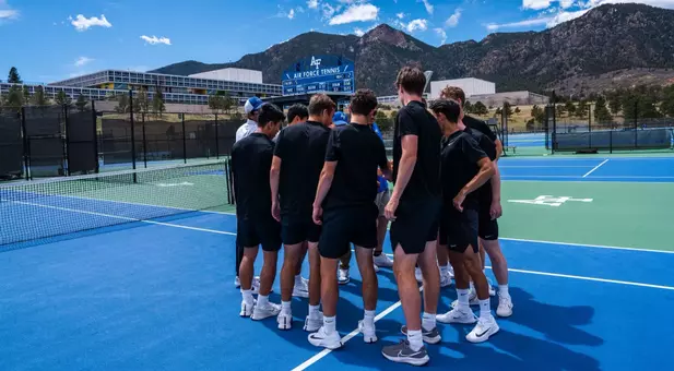 Men's Tennis team huddle before North Dakota match