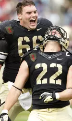 Will Wilson (66) and Nate Combs (22) celebrate Army's victory.