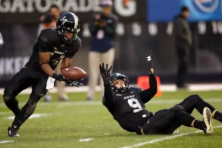 Nov 8, 2014; Bronx, NY, USA; Army Black Knights boundary corner Chris Carnegie (14) catches a interception after the ball was deflected by safety Hayden Pierce (9) at Yankee Stadium. Mandatory Credit: Danny Wild-USA TODAY Sports