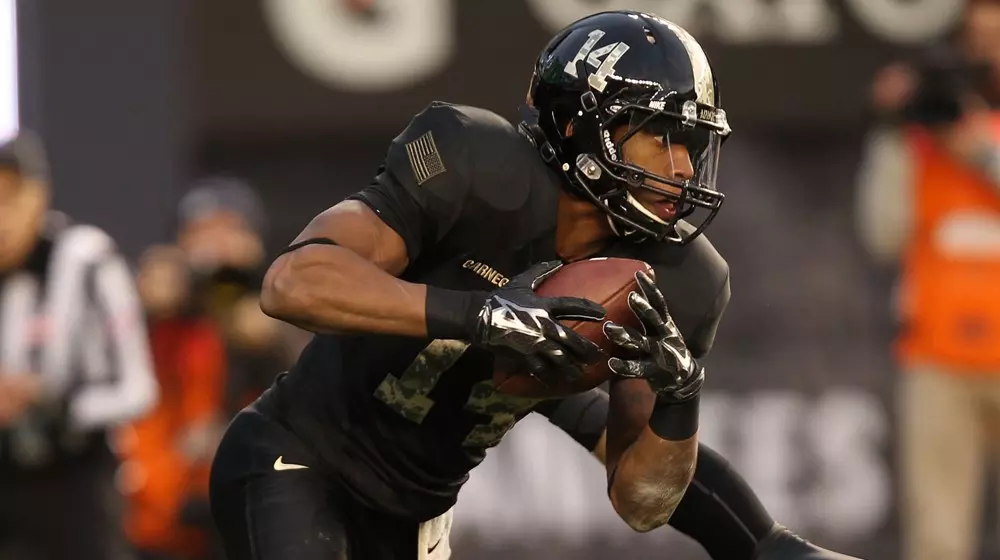 Nov 8, 2014; Bronx, NY, USA; Army Black Knights boundary corner Chris Carnegie (14) catches a interception after the ball was deflected by safety Hayden Pierce (9) at Yankee Stadium. Mandatory Credit: Danny Wild-USA TODAY Sports