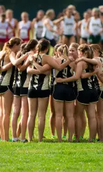 Women's cross country team huddles