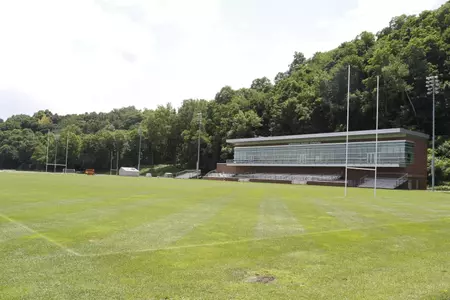 Photo of Anderson Rugby Complex facing the stands and building from the field.