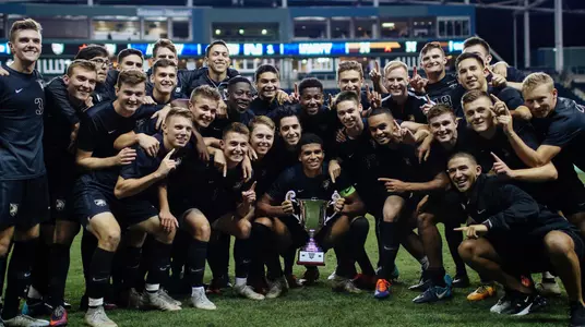 Army holds the Army-Navy Cup Trophy after defeating Navy 4-1.