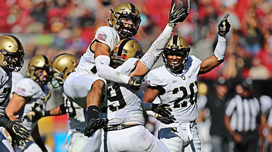 The Black Knights swarm Chandler Ramirez after the senior recovers a fumble in Army's victory over SJSU