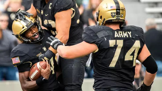 WEST POINT, NY - OCTOBER 20: Cam Thomas #4, Darnell Woolfolk #33, and Austin Schuffert #74 of the Army Black Knights celebrate Thomas' touchdown against the Miami of Ohio RedHawks at Michie Stadium on October 20, 2018 in West Point, New York. (Photo by Dustin Satloff/Getty Images) *** Local Caption *** Cam Thomas;Darnell Woolfolk;Austin Schuffert
