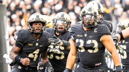 WEST POINT, NY - OCTOBER 20: Cam Thomas #4, Quinten Parker #85, and Darnell Woolfolk #33 of the Army Black Knights celebrate Woolfolk's touchdown in double overtime against the Miami of Ohio Redhawks at Michie Stadium on October 20, 2018 in West Point, New York.