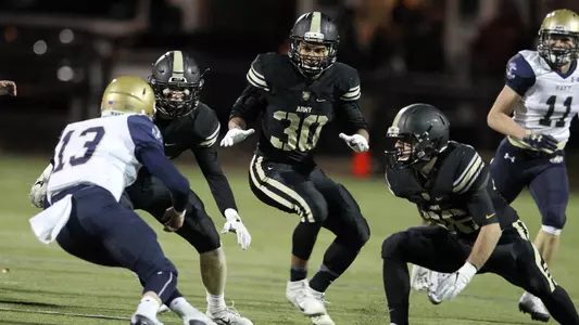Army defense closing in to make a tackle on Navy in 2018 CSFL Championship game