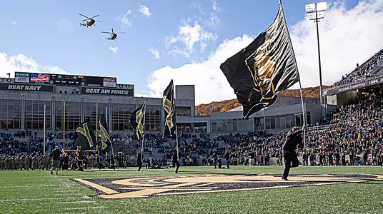 The Rabble Rousers carry the Army flags out onto the field prior to the Black Knights' game with Air Force