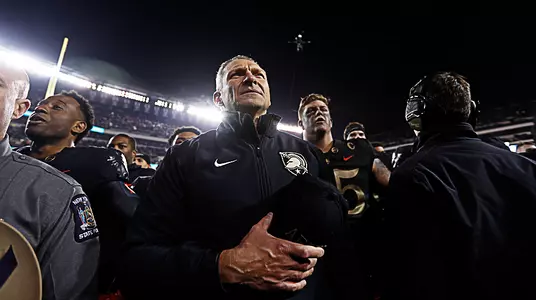Army head football coach Jeff Monken stands in front of the Corps of Cadets after his team defeated Navy for the third-straight season.