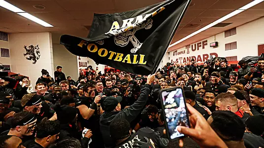 Coach Jeff Monken waves the team's Black Flag after leading the Black Knights to their third-straight win over rival Navy.