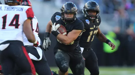 Running Back Darnell Woolfolk runs up the middle in Armed Forces Bowl vs. San Diego State