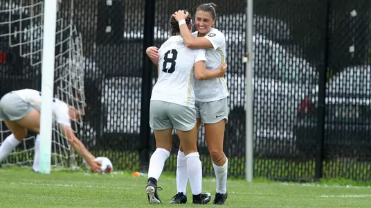 Sydney Witham celebrating a goal with Trinity Garay vs. Marshall