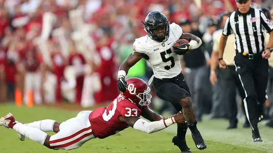 Running back Kell Walker escapes a tackle at #5 Oklahoma.