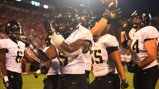 Running Back Kell Walker and teammates celebrate a touchdown at Oklahoma on Sept. 22, 2018