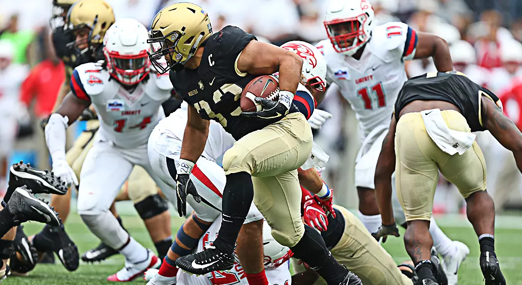 Senior fullback Darnell Woolfolk shakes Liberty defenders en route to an Army touchdown
