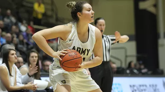 Julia Gibbs looks for a player to pass to during the game against Connecticut College.