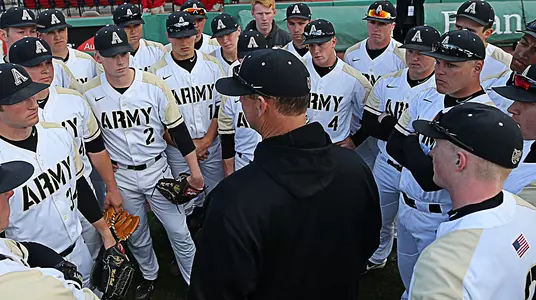 Head baseball coach Jim Foster speaks with the team prior to their game against Navy at Fenway Park