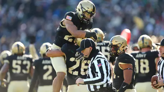 Elijah Riley celebrates with teammate Ryan Velez after an interception against UMass on Nov. 9, 2019.