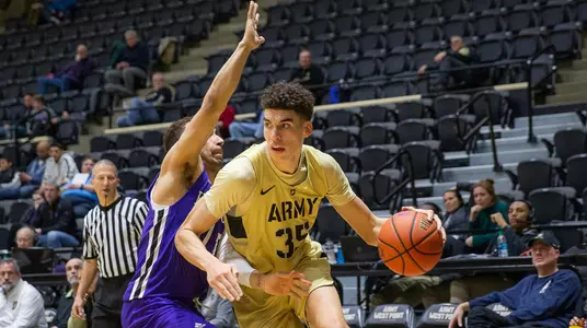 Alex King drives past a defender