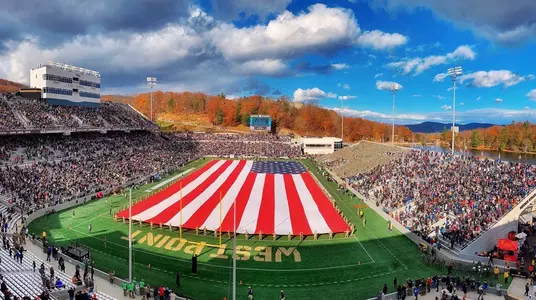 Fans help the Rabble Rousers spread the American Flag during halftime of the Army football game