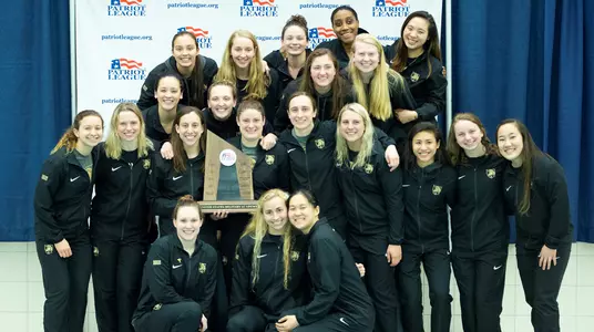 Women's swim and dive poses after taking second at league championships
