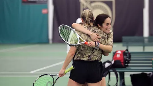 Paola Bou and Genevieve McCormick celebrate winning the doubles point for Army