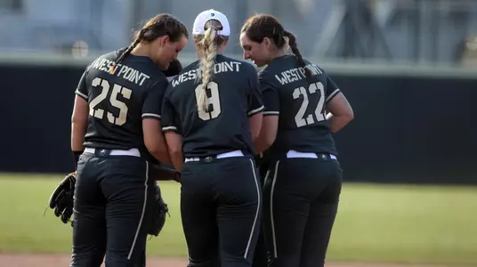 Army softball huddling during a home game