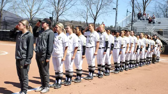 Army softball saluting during the national anthem