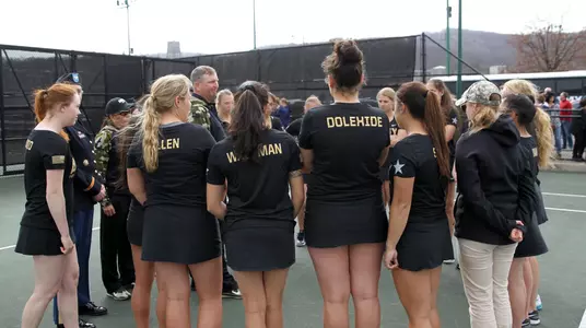 Women's tennis team huddle vs. Navy