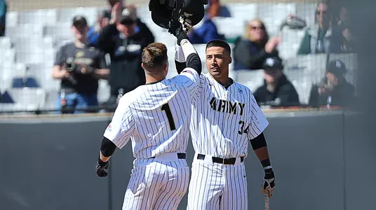 Andre Walden and Anthony Giachin celebrate after Giachin recorded a home run against Navy