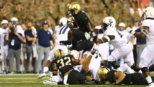 Quarterback Kelvin Hopkins Jr. jumps over the line during Army's 14-7 win over Rice on Aug. 30, 2019.