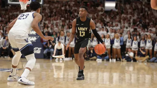 Lonnie Grayson dribbles the ball at the top of the key