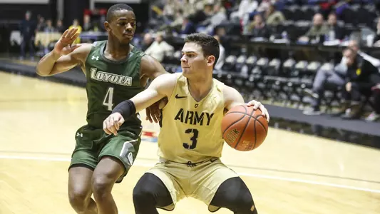 Tommy Funk drives past a Loyola defender