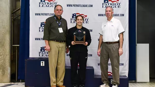Serica Hallstead poses with the female diver of the meet trophy from the Patriot League