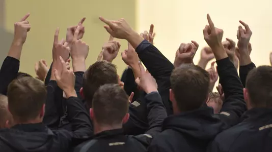 Men's swim and dive team huddles